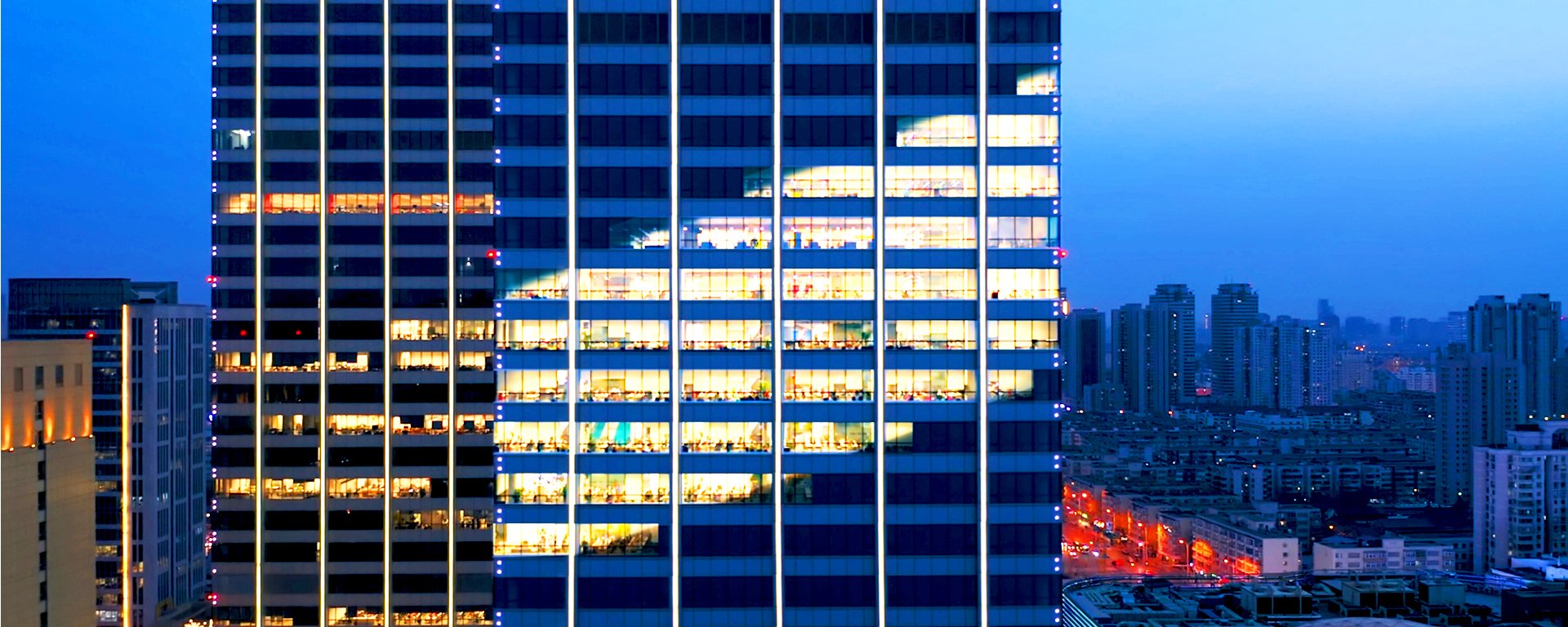Building with lights in the shape of the RJF Pro logo.