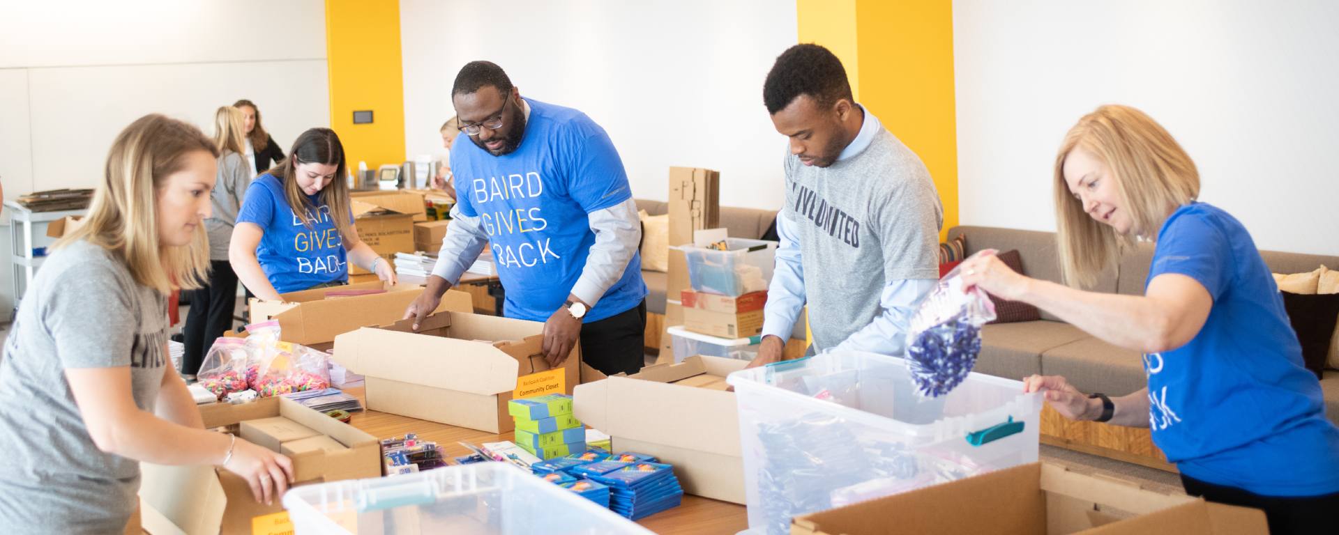 Group of RJF Pro Associates packing food boxes.